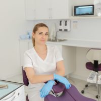 Portrait of female dentist .She standing in her dentist office.